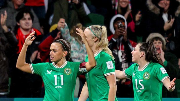 Ireland captain Katie McCabe pictured (left) after scoring her country's first ever goal at a Women's World Cup in July 2023